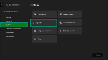 Xbox Settings menu with System selected and the Updates option highlighted.