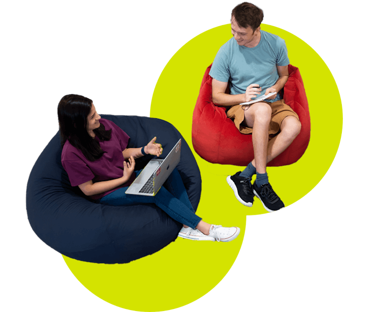 people sitting on beanbags with laptops and notepads
